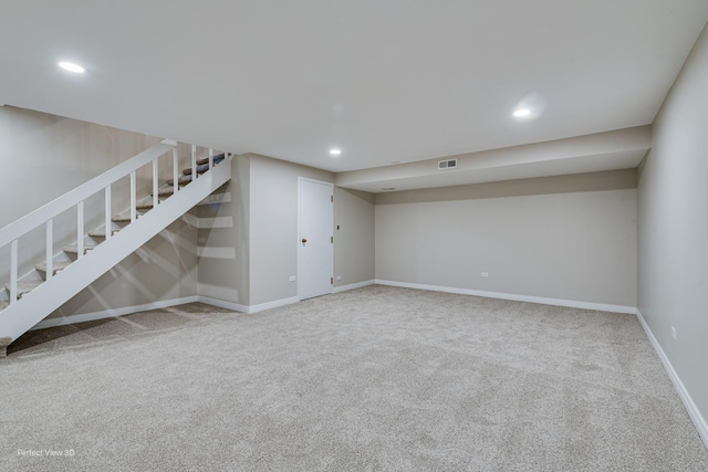 finished below grade area with recessed lighting, baseboards, carpet floors, and stairs