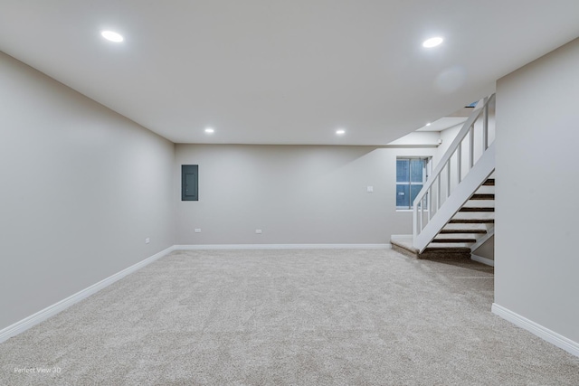 finished basement with recessed lighting, baseboards, stairs, and carpet