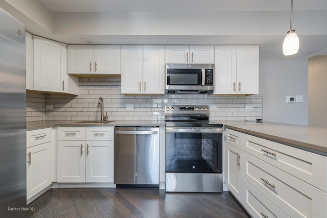 kitchen with a sink, dark wood-type flooring, white cabinets, and stainless steel appliances