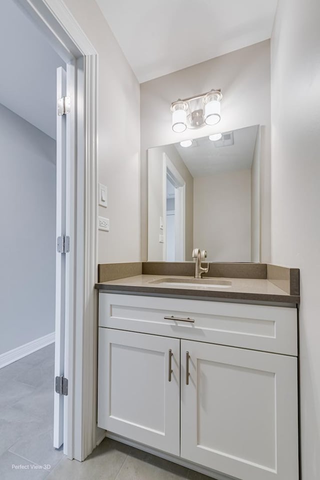 bathroom with tile patterned floors, vanity, and baseboards