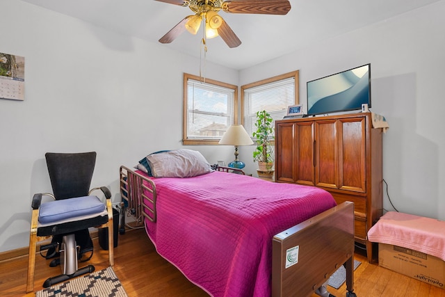 bedroom featuring a ceiling fan and wood finished floors