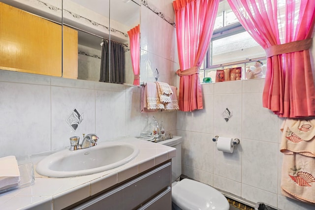 full bathroom featuring backsplash, toilet, tile walls, and vanity