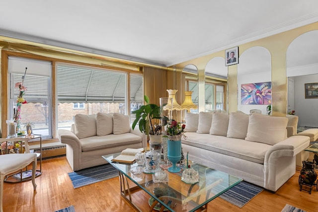 living room with baseboard heating, hardwood / wood-style floors, and ornamental molding