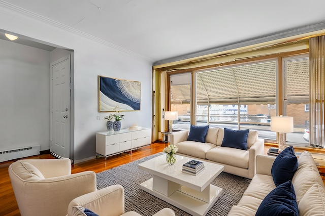 living area featuring ornamental molding, a baseboard heating unit, and wood finished floors