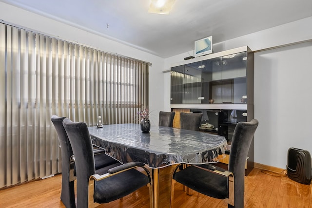 dining area featuring baseboards and wood finished floors