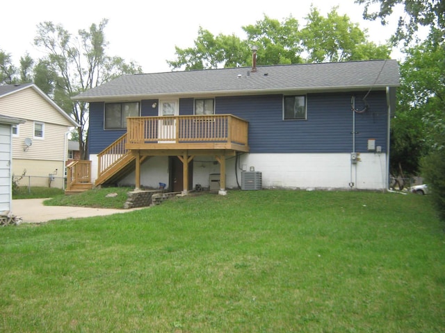 rear view of property with a deck, a yard, central AC unit, and stairs