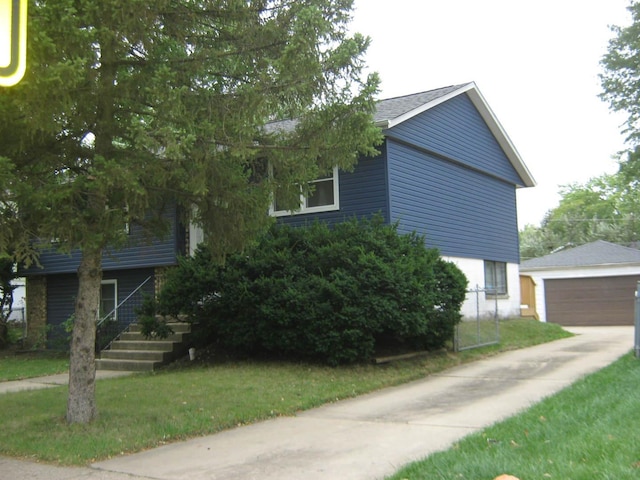 view of side of home with an outdoor structure and a garage