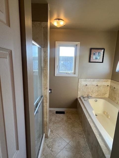 full bath with a shower stall, a bath, baseboards, and tile patterned floors