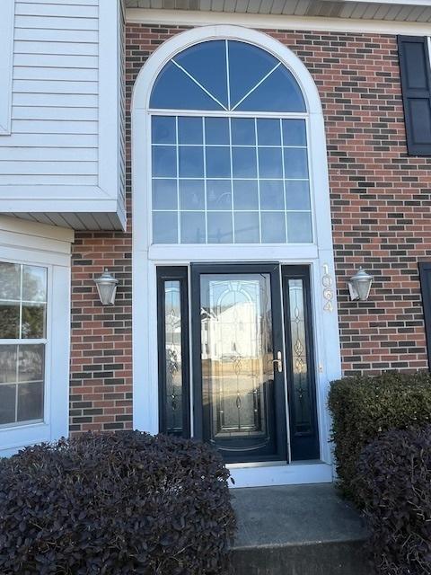 entrance to property with brick siding