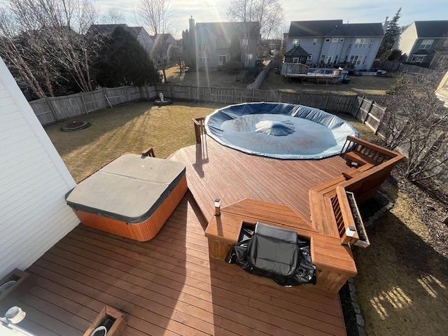 exterior space with a fenced backyard and a hot tub