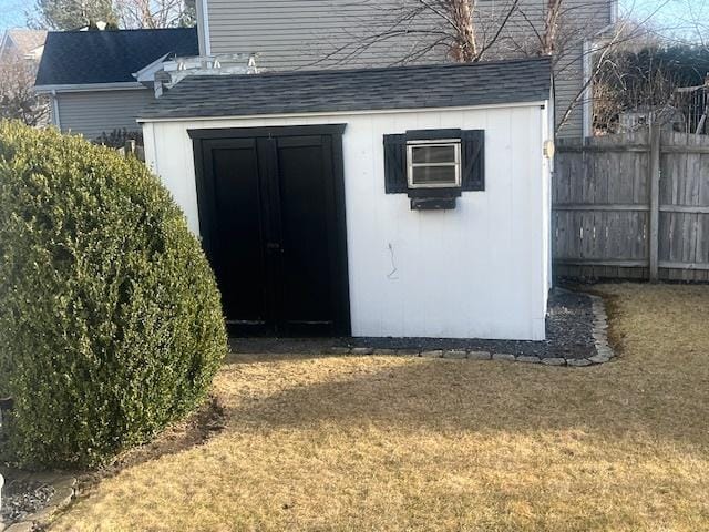 view of shed featuring fence