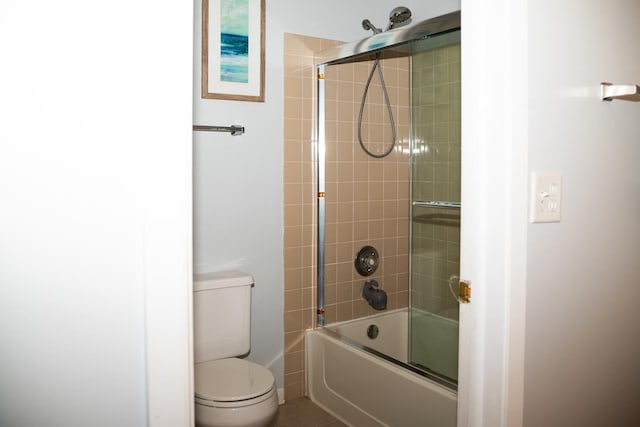 bathroom featuring toilet and enclosed tub / shower combo