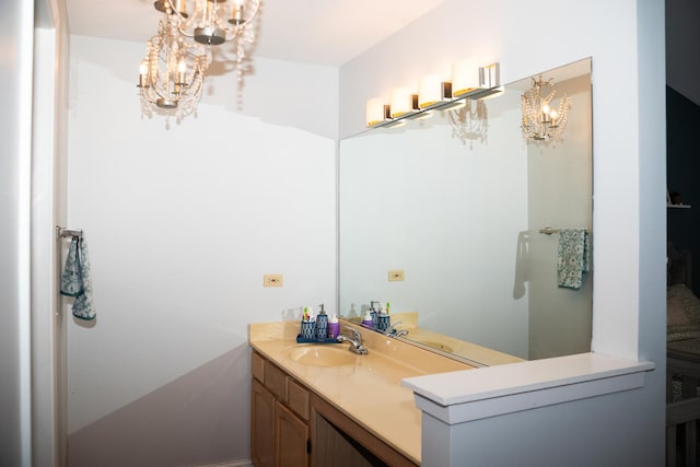 bathroom featuring vanity and a notable chandelier