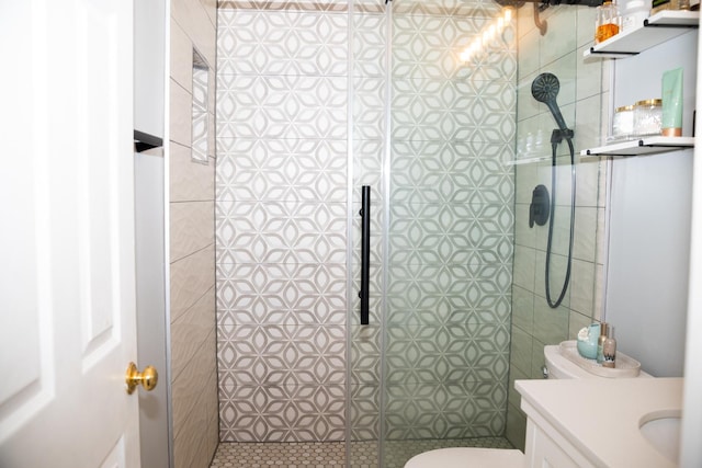 full bathroom with vanity, toilet, and tiled shower