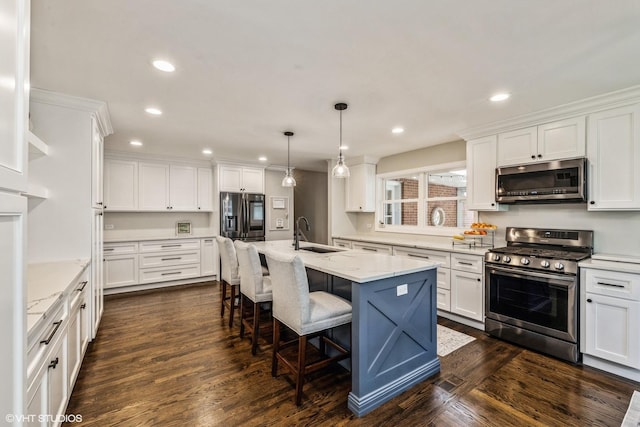 kitchen featuring a sink, stainless steel appliances, dark wood-type flooring, and white cabinets