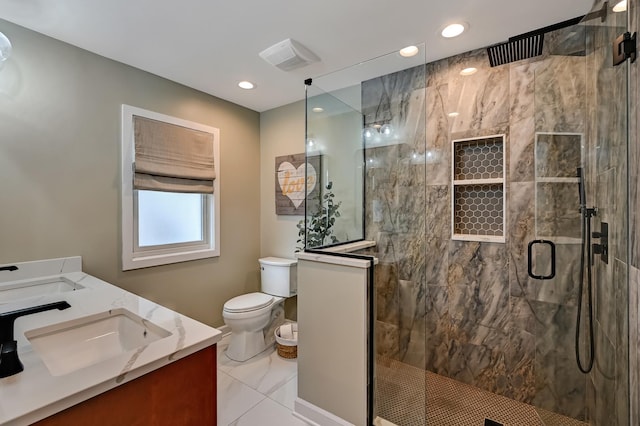 bathroom with a shower stall, toilet, double vanity, and a sink