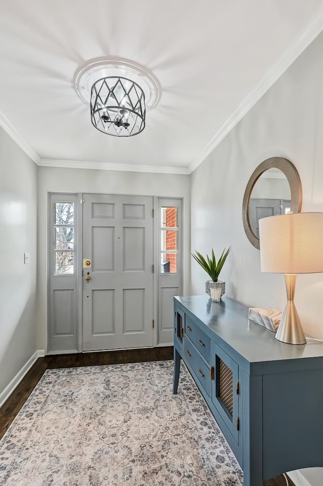 foyer featuring dark wood-style floors, baseboards, and ornamental molding