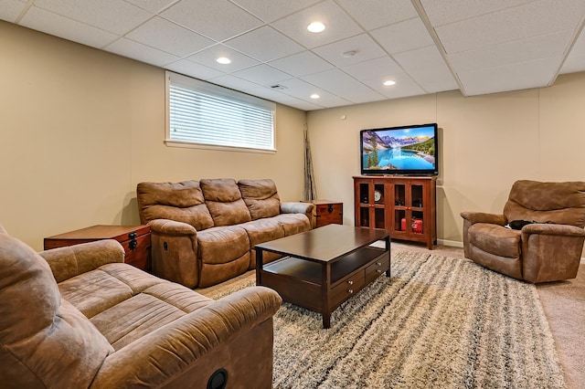 carpeted living area featuring recessed lighting and a drop ceiling