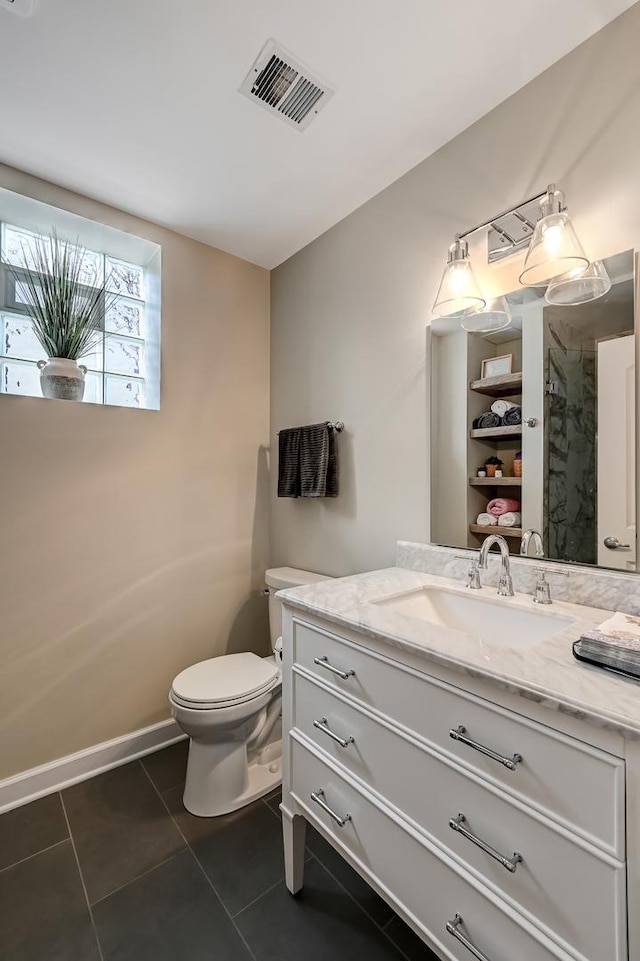 bathroom with visible vents, toilet, tile patterned flooring, baseboards, and vanity