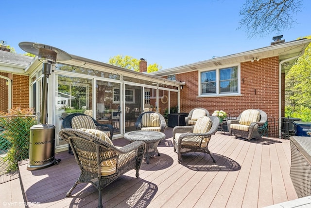 wooden deck with a sunroom