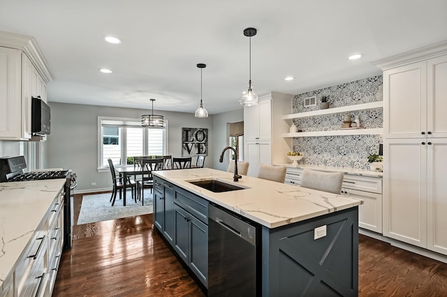 kitchen with open shelves, a kitchen island with sink, a sink, stainless steel appliances, and white cabinetry