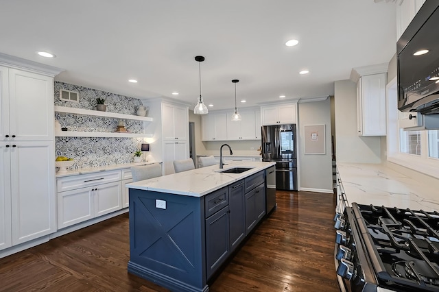 kitchen with black appliances, white cabinets, and a sink