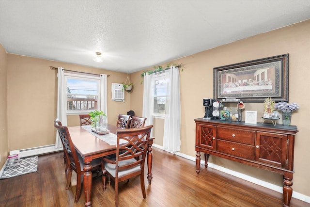 dining area featuring an AC wall unit, wood finished floors, baseboards, and baseboard heating