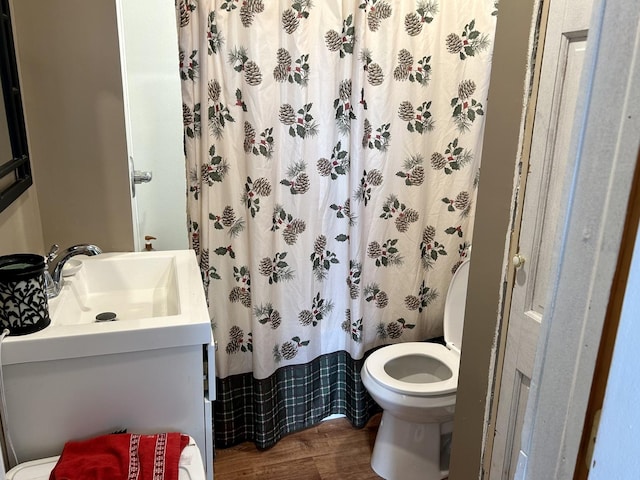 full bath with toilet, vanity, a shower with shower curtain, and wood finished floors