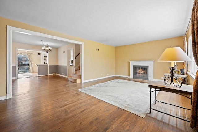 4708 Lawn Ave, Western Springs, IL 60558 - living room with a fireplace with flush hearth, wood finished floors, baseboards, and stairway