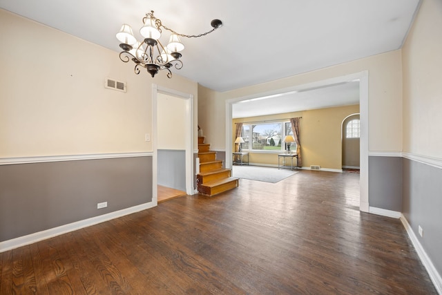 4708 Lawn Ave, Western Springs, IL 60558 - unfurnished room with visible vents, baseboards, an inviting chandelier, stairway, and wood finished floors