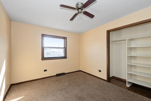 unfurnished bedroom featuring carpet, baseboards, a closet, and ceiling fan