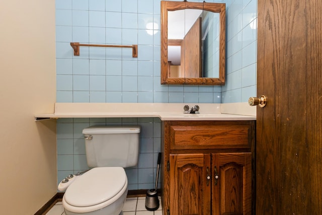 bathroom with vanity, tile walls, toilet, and tile patterned flooring