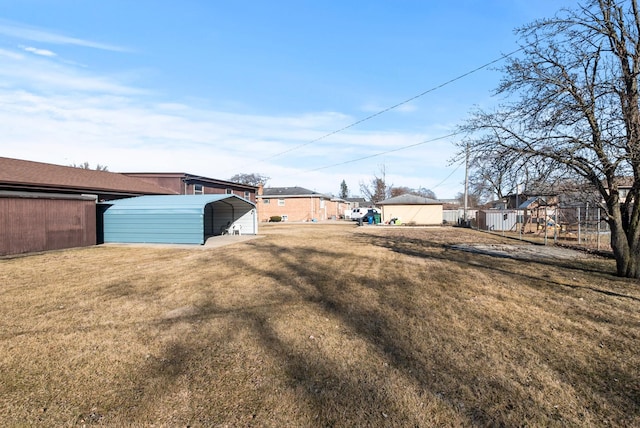 view of yard featuring a residential view, a carport, and a playground