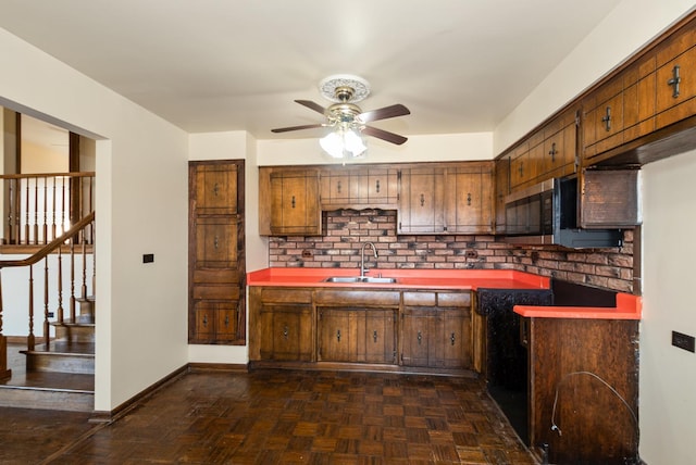 kitchen with tasteful backsplash, stainless steel microwave, baseboards, ceiling fan, and a sink