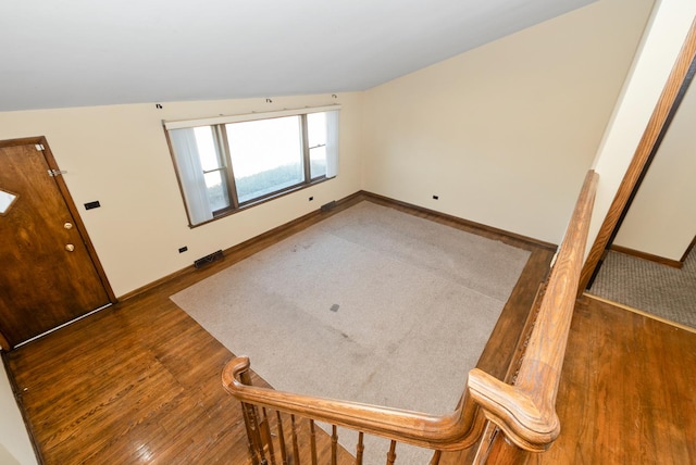 foyer with visible vents, baseboards, and wood finished floors