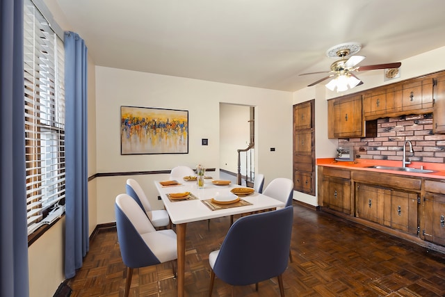 dining area with baseboards and ceiling fan