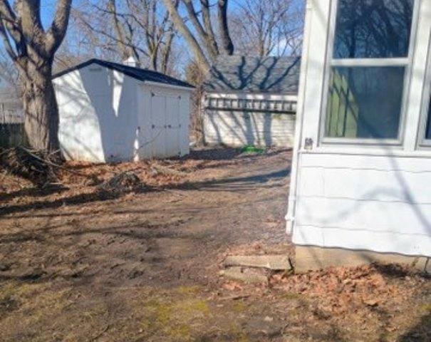 exterior space featuring an outdoor structure and a shed