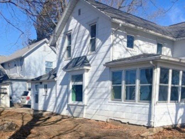 view of side of home featuring a sunroom