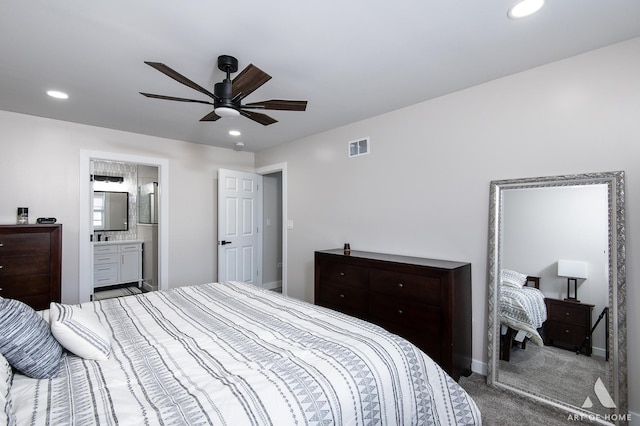 carpeted bedroom with a ceiling fan, visible vents, baseboards, ensuite bath, and recessed lighting