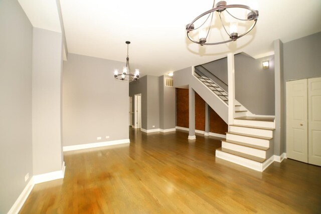 entrance foyer featuring stairway, baseboards, and wood finished floors