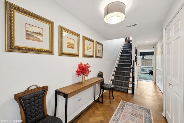 hall featuring stairs, recessed lighting, and visible vents