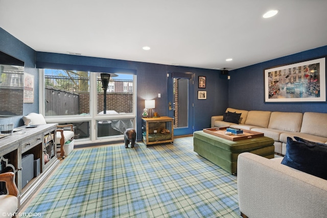 carpeted living area with recessed lighting and visible vents