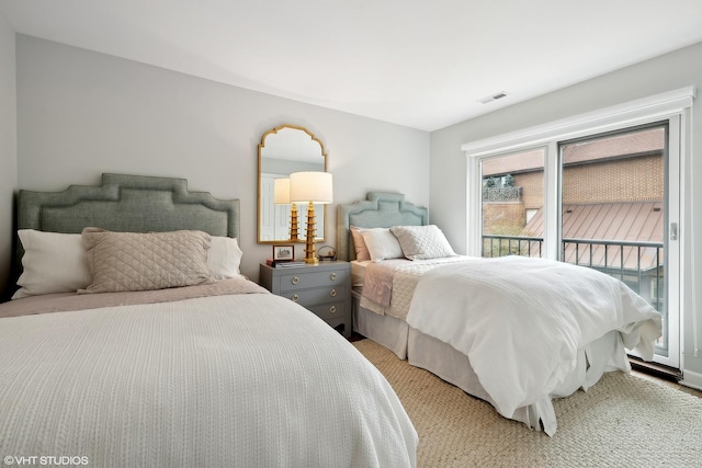 bedroom featuring access to outside and visible vents