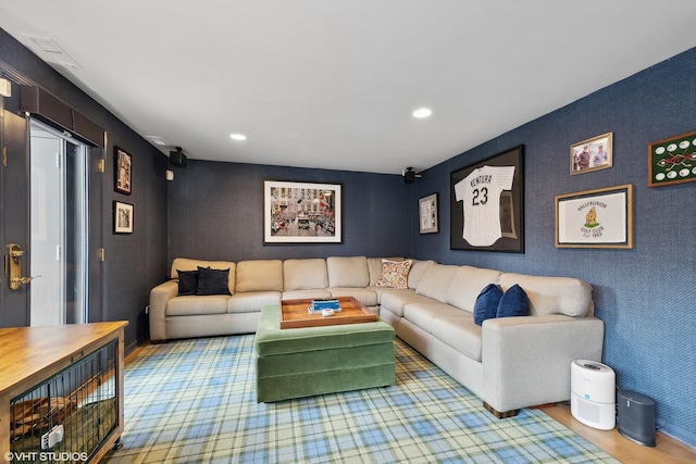 living area featuring recessed lighting, wood finished floors, and an accent wall