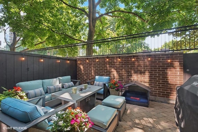 view of patio with an outdoor hangout area, a grill, and fence