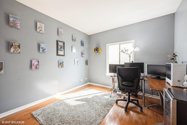 office area with baseboards and light wood-style floors