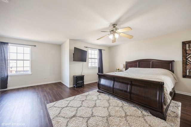 bedroom with a ceiling fan, baseboards, and wood finished floors