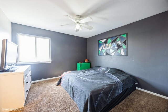 bedroom with light colored carpet, baseboards, and ceiling fan