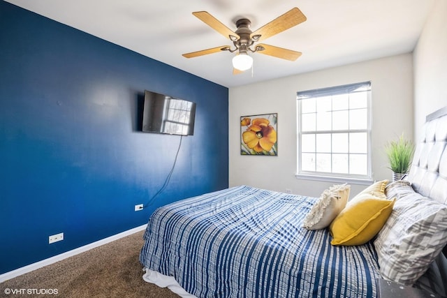 bedroom with a ceiling fan, baseboards, and carpet floors