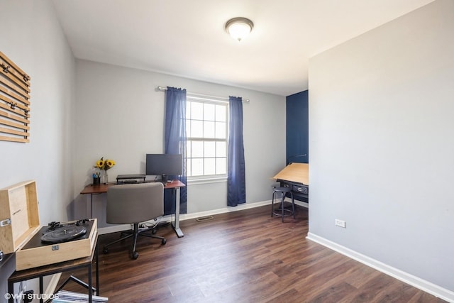 office with visible vents, baseboards, and wood finished floors